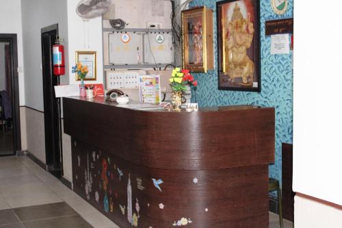 a bar in a room with a counter with flowers at p p motel in Alibaug
