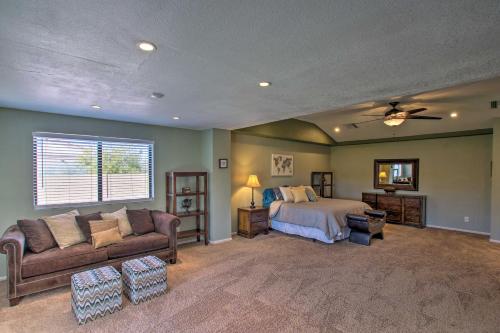 a bedroom with a bed and a couch at Pet-Friendly Glendale Home with Pool and Putting Green in Phoenix