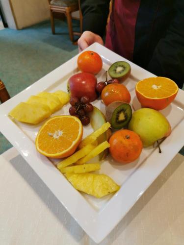 a plate of fruits and vegetables on a table at Hotel Cristal in Nürnberg