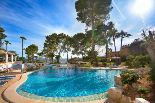 a swimming pool in a resort with palm trees at Hipotels Eurotel Punta Rotja Spa-Golf in Costa des Pins