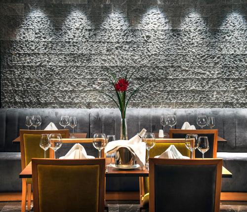 a dining room with a table with wine glasses at Ilayda Avantgarde Hotel in Kusadası