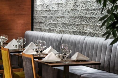a row of tables with wine glasses and napkins at Ilayda Avantgarde Hotel in Kusadası