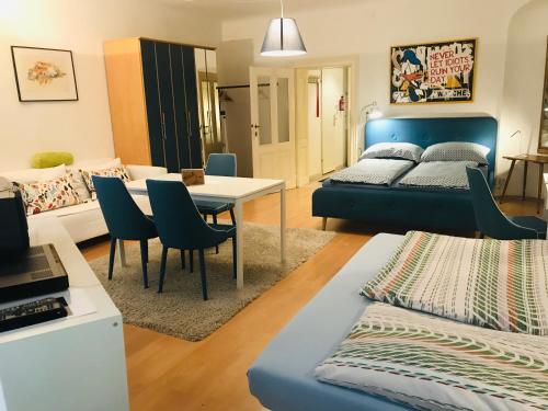 a room with a bed and a table and chairs at The Barts City Center - Self Check-in in Vienna