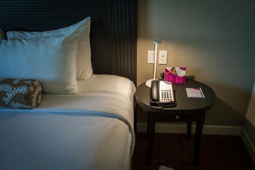 a hotel room with a bed and a phone on a table at Crowne Plaza Managua by IHG in Managua