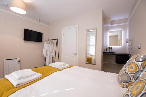 a bedroom with a large bed with a yellow blanket at Redhouse in Salisbury