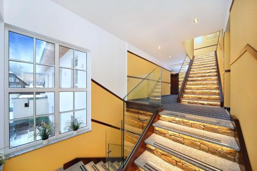 a staircase in a house with a window at Hotel Central 1920 in Špindlerův Mlýn