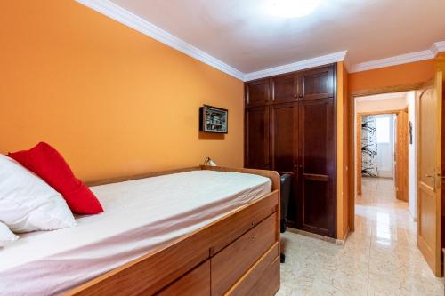 a bedroom with a bed and a wooden cabinet at Flatguest Ingenio + 2 Bdr + Wifi + 4PAX in Ingenio