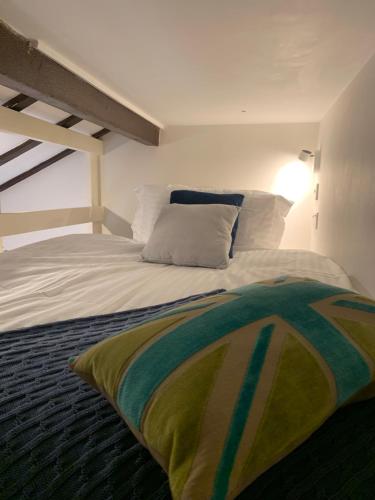 a bedroom with a bed with a pillow on it at Stunning Barn private hot tub Worcester & Malvern Sleeps 6 in Worcester