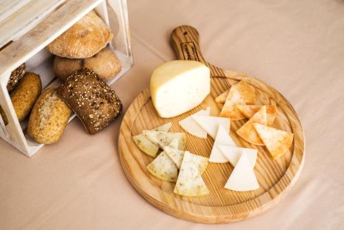 a plate of cheese and bread on a table at Lam Hotel Convento do Desagravo in Oliveira do Hospital