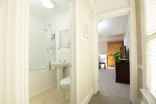 a bathroom with a toilet and a shower and a sink at Salt Lane Apartments in Salisbury