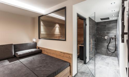 a living room with a couch and a shower at Alpenchalet Montafon in Gaschurn