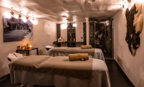 
a hotel room with a bed, table and chairs at Les Suites – Maison Bouvier in Tignes
