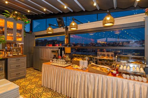 a restaurant with a counter with food on it at Alpek Hotel in Istanbul