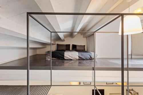 a bedroom with a bed in a loft at Nido alla Giudecca con terrazza by Wonderful Italy in Siracusa