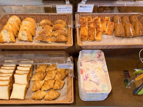 a variety of pastries on display in a bakery at Nisshin Namba Inn in Osaka