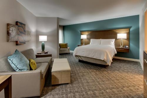 a hotel room with a bed and a couch at Staybridge Suites Missoula by IHG in Missoula
