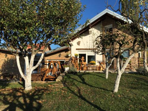 a house with trees in front of it at Matanovi Dvori in Slavonski Brod