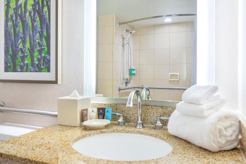 a bathroom with a sink with towels on a counter at Crowne Plaza New Orleans French Qtr - Astor by IHG in New Orleans