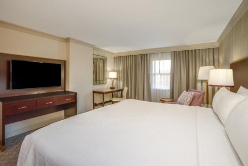 a hotel room with a bed and a flat screen tv at Crowne Plaza New Orleans French Qtr - Astor by IHG in New Orleans