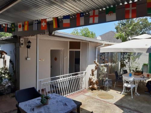 a patio with a table and an umbrella at Lavender Lane in Ladysmith
