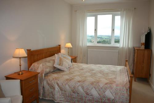 a bedroom with a bed and a window at Torlands in Monmouth