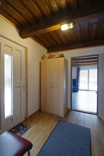 a living room with a door open to a room at Chalupa Pohoda Demänová in Liptovský Mikuláš – Demänová