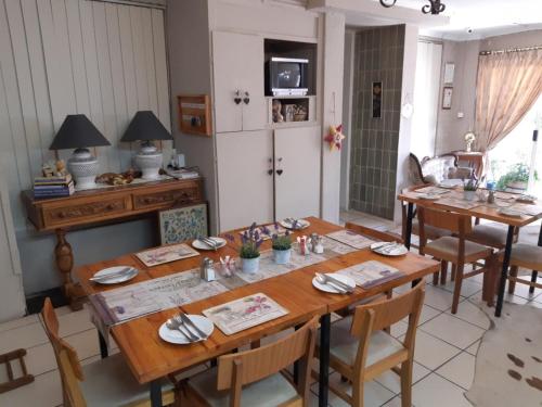 a dining room with a wooden table and chairs at Lavender Lane in Ladysmith