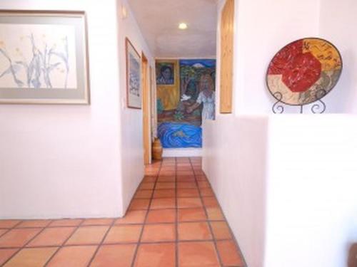 Casas de Guadalupe - Sante Fe Vacation Rentals في سانتا فيه: مدخل منزل مع غرفة مع سرير