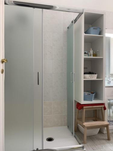 a shower with a glass door in a bathroom at Casa di Alice Luxury Hospitality - Elevator, Fast WiFi in Syracuse