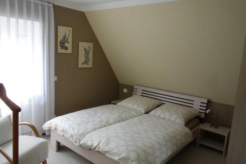een slaapkamer met een bed en een raam bij Ferienwohnung Itzgrundblick in Großheirath