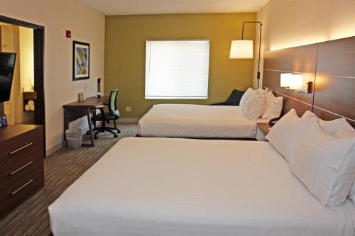 a hotel room with two beds and a desk at Holiday Inn Express Branford-New Haven by IHG in Branford