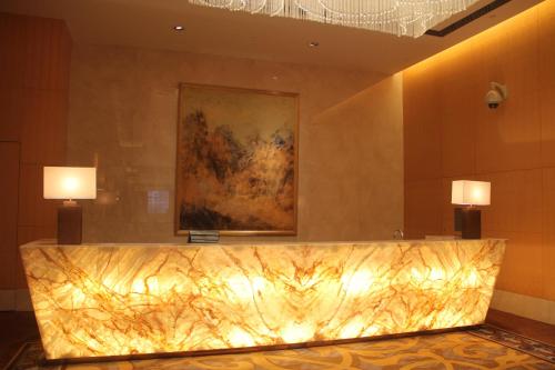 a lobby with two lights on the wall at Crowne Plaza Yichang by IHG in Yichang