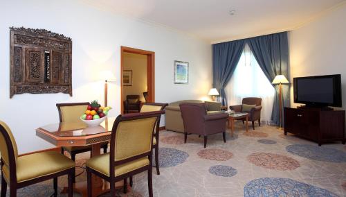 a hotel room with a living and dining room at Holiday Inn Al Khobar by IHG in Al Khobar