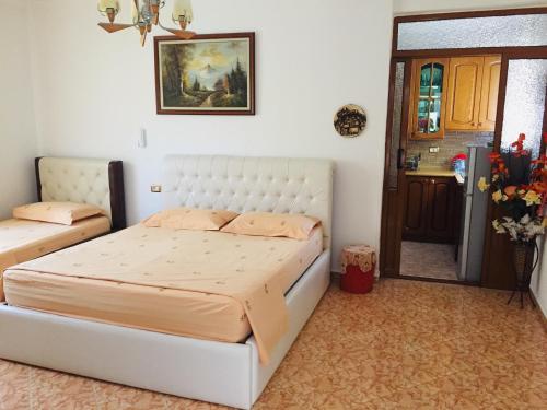 a bedroom with a large white bed in a room at Jemin Apartment in Berat