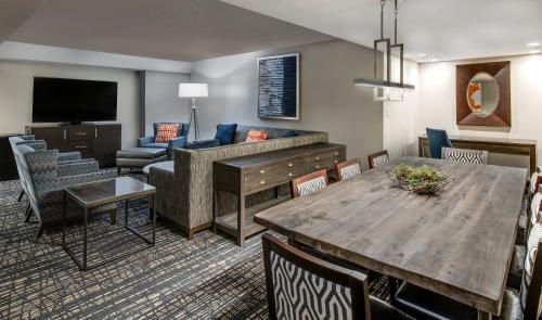 a living room with a table and a couch at Crowne Plaza Annapolis by IHG in Annapolis