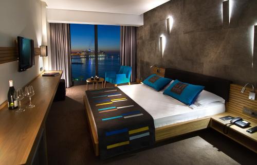 a bedroom with a bed with a view of the water at Ilayda Avantgarde Hotel in Kuşadası