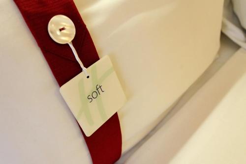 a red neck tie with a tag on it at Holiday Inn Express Birmingham Redditch by IHG in Redditch