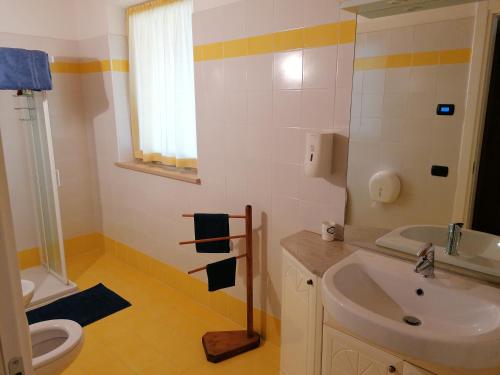 a bathroom with a sink and a toilet at Az. Agr. Sponga Giancarlo in Lèvego