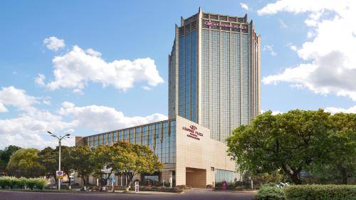 a large building with a sign on the side of it at Crowne Plaza Zhenjiang by IHG in Zhenjiang