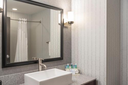 a bathroom with a sink and a mirror at Holiday Inn Express & Suites Columbus - Polaris, an IHG Hotel in Columbus