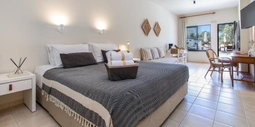 a bedroom with a bed and a living room at Kanso Rooms in Galatás