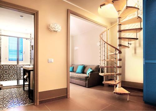 a spiral staircase in a living room with a couch at Cala del Porto Residence in Marettimo