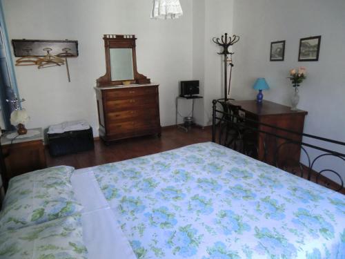 a bedroom with a bed and a dresser and a mirror at B&B Leon D'Oro in Pusiano