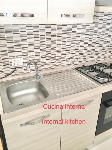 a kitchen with a sink and a stove at L'attico di Greta,Etna house in Mascalucia