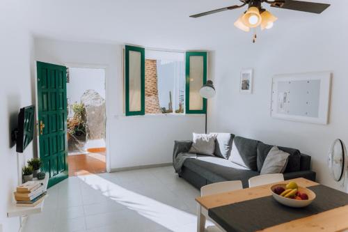 a living room with a couch and a table at Central location in a great complex with 300mbps internet in Puerto del Carmen