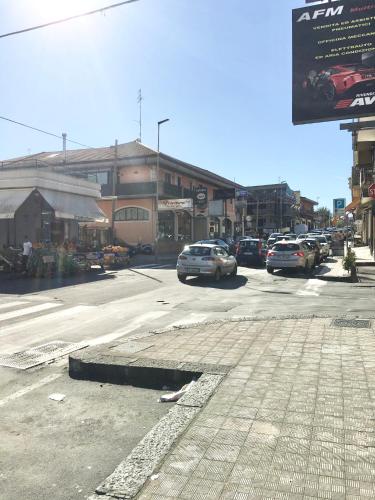 a city street with cars parked on the street at L'attico di Greta,Etna house in Mascalucia