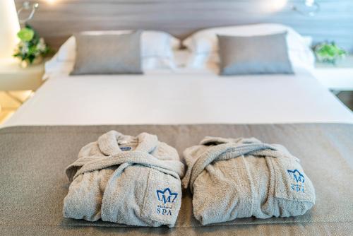 A bed or beds in a room at Majestic Beach Hotel & Wellness