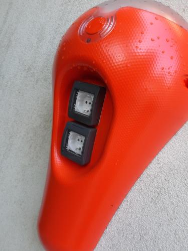 an electronic device with an orange object with two switches at Hotel Valeria in Villa Opicina