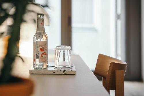 a bottle of beer sitting on a table with a glass at Haus im Tal in Munich