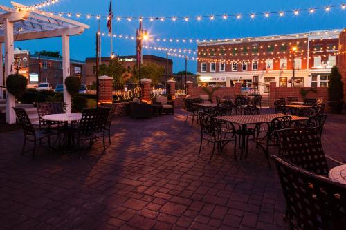 a patio with tables and chairs and lights at night at The Bolling Wilson Hotel in Wytheville